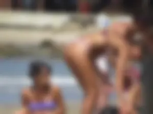 Girl with a great ass in thong bikini on the beach