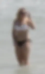 Big boobed thick blonde on the beach in a bikini