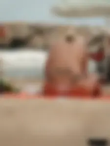 Tattooed blonde with big tits topless and in thong