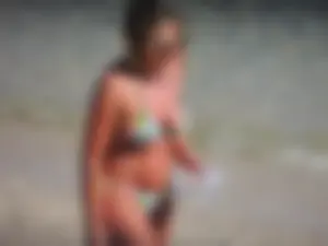 Blonde milf on the beach in her bikini
