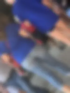 Bunch of girls in various outfits at a Cardinals baseball game