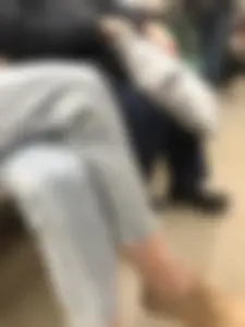 Candid cutie sitting with crossed legs in a subway train wearing jeans