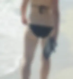 Lady on the beach in black bikini with nice ass
