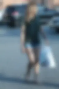 Cutie walking in the parking lot in jean shorts