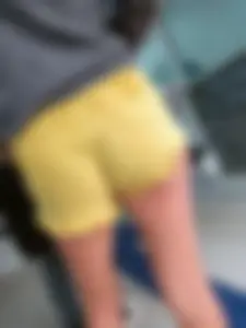 Skinny ass eating her yellow shorts