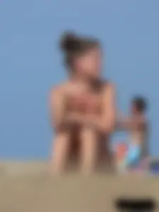 Sexy babe with a nice body topless and in a thong on the beach