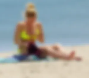 Sexy ass blonde milf on the beach in a thong with cameltoe and bending over