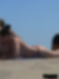Purple thong topless lady on the beach gets oiled up by her husband