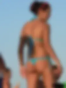 A bunch of hot babes on the beach in thong bikinis