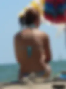 A bunch of hot babes on the beach in thong bikinis