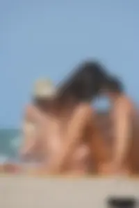 2 topless girls at the beach in thongs