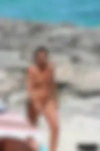 Older lady on a nude beach showing her body