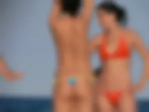 Topless beach babe with nice tits and ass in blue thong bikini