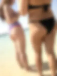 Candid girls standing in water at the beach