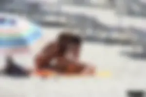Topless milf and her topless daughter on the beach