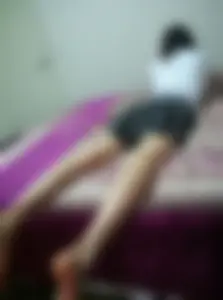 Girl Lying in Bed in a Skirt with Her Skinny Legs Spread