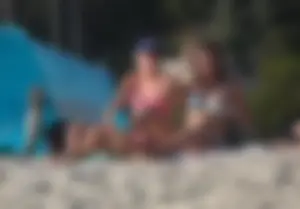 Two sexy friends out on the beach in bikinis