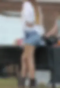 Hippie type dressed girl in denim shorts with a nice ass