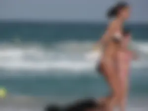 Skinny and sexy lady in a bikini playing on the beach