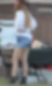 Hippie type dressed girl in denim shorts with a nice ass