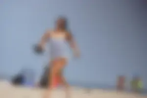 Trio of girls in bikinis on the beach and one with an incredible ass