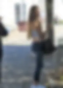 Sexy blonde girl in tight jeans and showing midriff