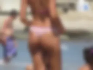 Girl with a great ass in thong bikini on the beach