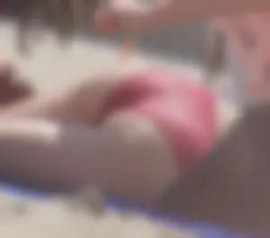 A group of teens in bikinis on the beach