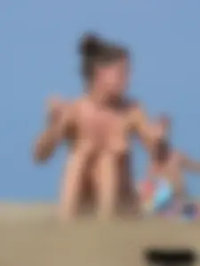 Sexy babe with a nice body topless and in a thong on the beach