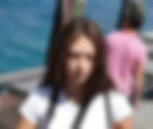 Pretty girl with a camera in little denim shorts