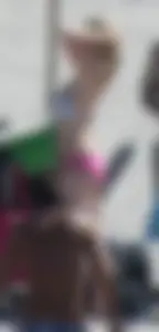 Skinny blonde girl on the beach in her pink and white bikini