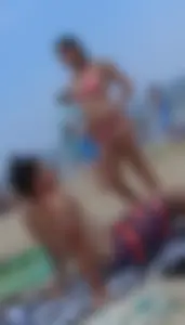 Pierced nipples hottie in pink at the beach