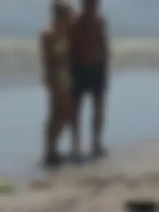Sexy blonde on the beach in a yellow thong bikini
