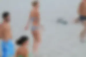 Sexy girl playing beach volleyball in a bikini