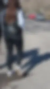 A beautiful little brunette walking in the park. tight black leggings