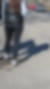 A beautiful little brunette walking in the park. tight black leggings