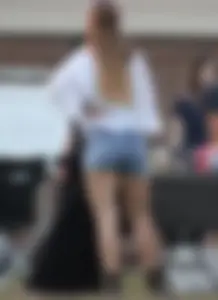 Hippie type dressed girl in denim shorts with a nice ass