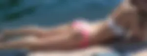 Pink bikini bottom girl laying in the sun up close