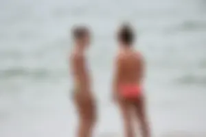 Two sexy ass girls on the beach in bikinis
