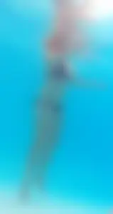 Underwater shots of a bikini teen swimming in the pool