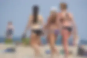 3 sexy girls with nice asses walking on the beach in bikinis