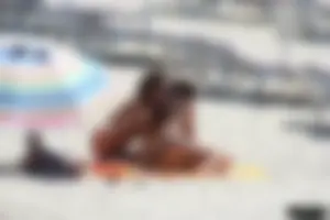 Topless milf and her topless daughter on the beach