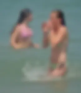 Milf at the beach in the water with hard nipples and a nice body