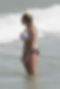 Big boobed thick blonde on the beach in a bikini