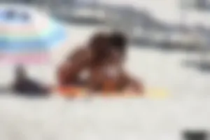 Topless milf and her topless daughter on the beach
