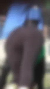 Sexy brunette in see thru leggings stretching before a run with a green thong
