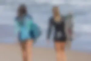Candid girls surfing on the beach