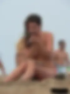 Sexy babe with a nice body topless and in a thong on the beach