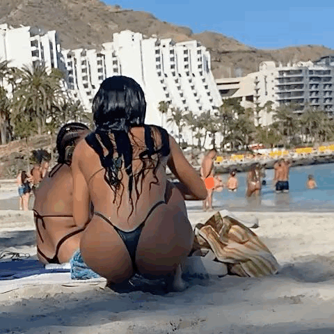 Amazing ass on the beach wearing a Green micro bikini