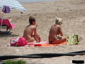 Tattooed blonde with big tits topless and in thong